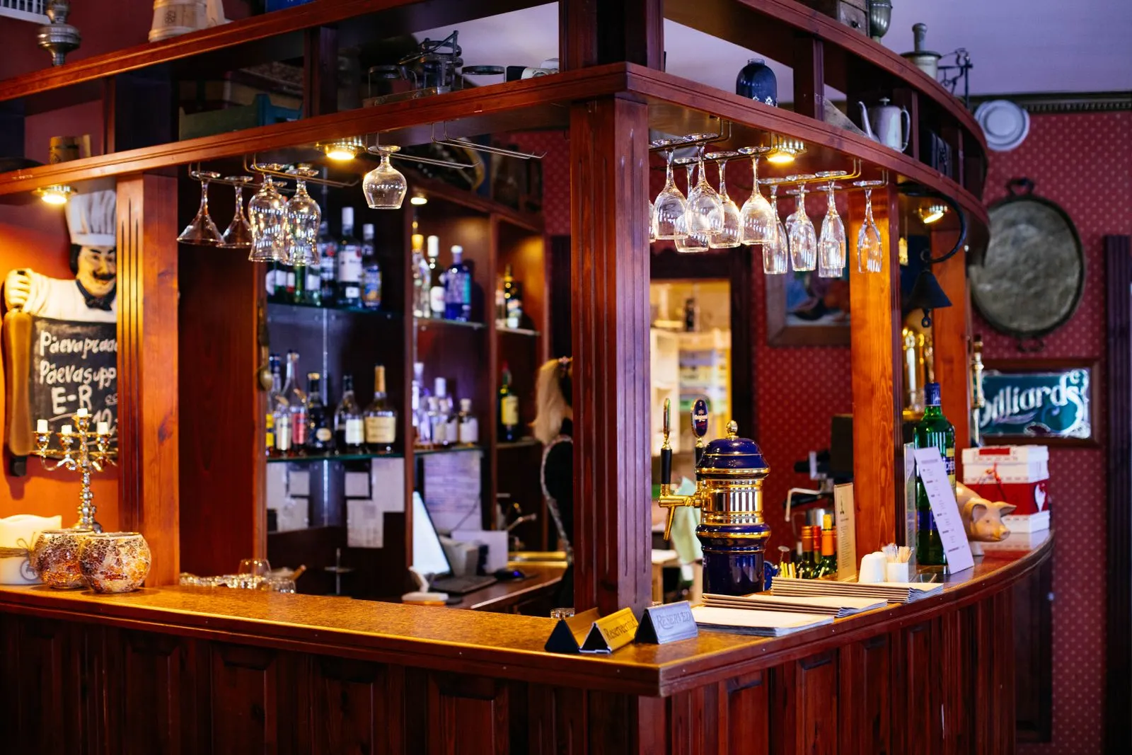Warm pub interior with a wooden bar where guests scan a QR code drink menu