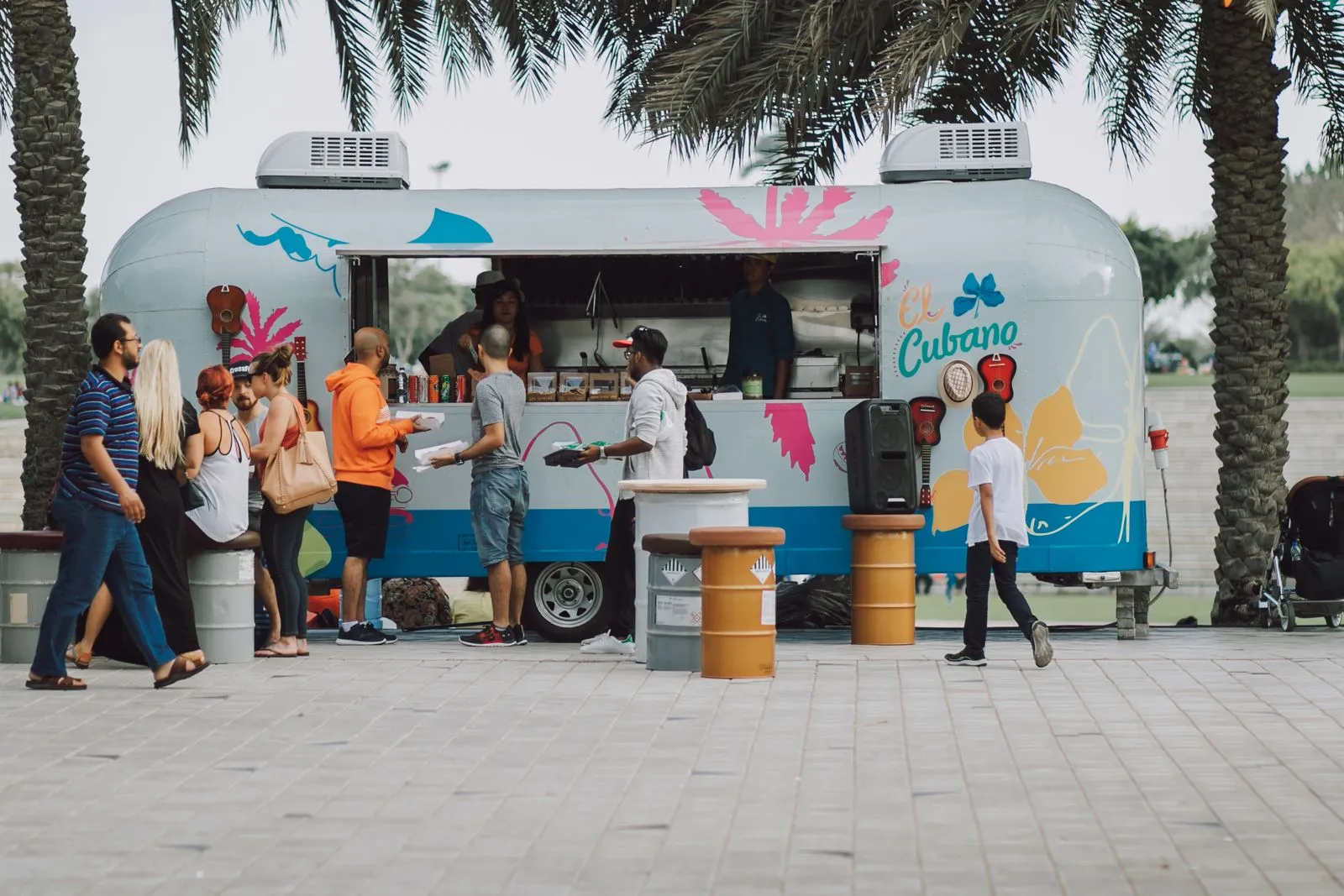 Customers ordering at a food truck with a QR code menu on the service window