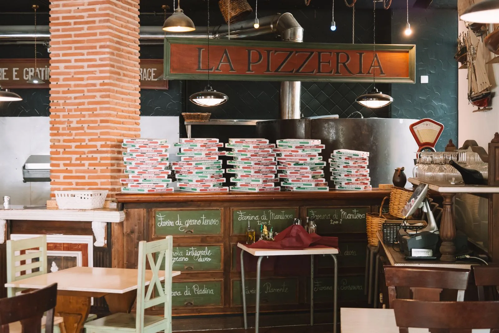 Cozy pizzeria interior where guests scan a QR code menu at the table