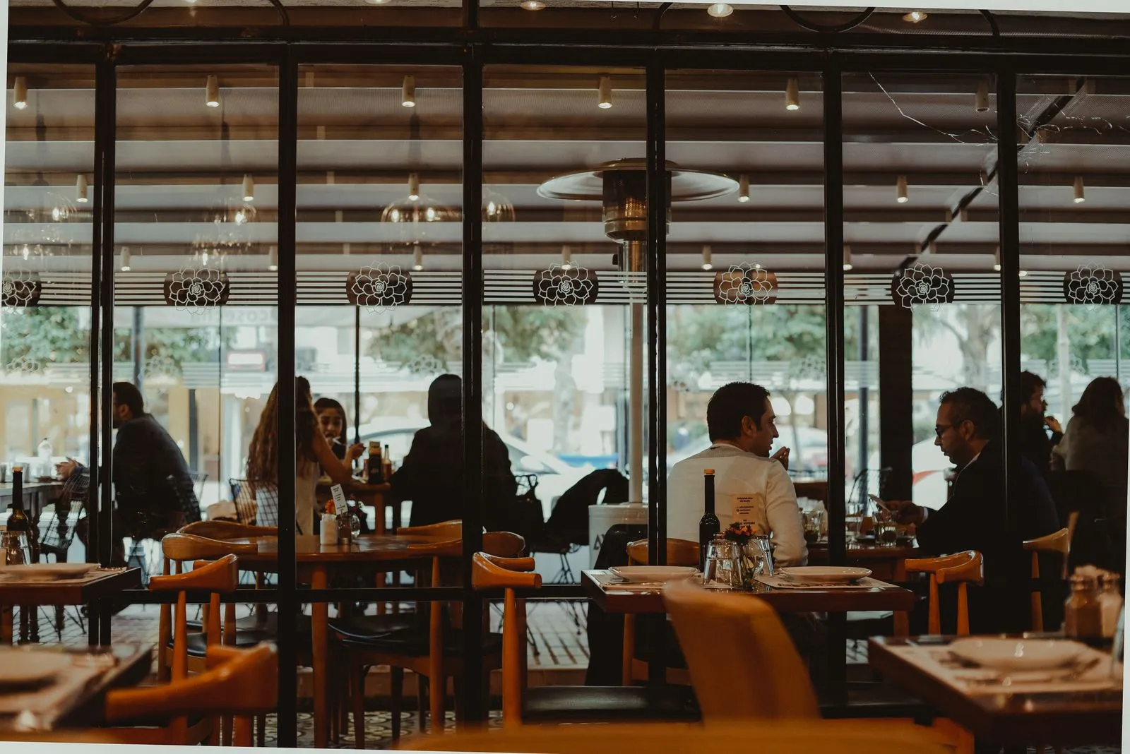 Restaurant dining room where guests browse a QR code menu on their phones